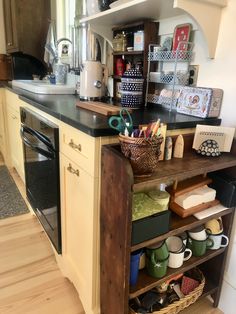 a kitchen with an oven, sink and shelves filled with various items on the counter