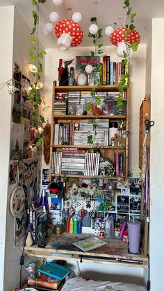 a room filled with lots of clutter and books on top of a wooden shelf