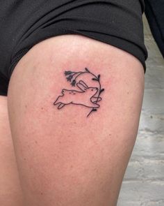 a woman's thigh with a small tattoo of a pig on the back of her leg