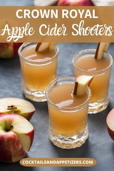 three glasses filled with apple cider shots on top of a table