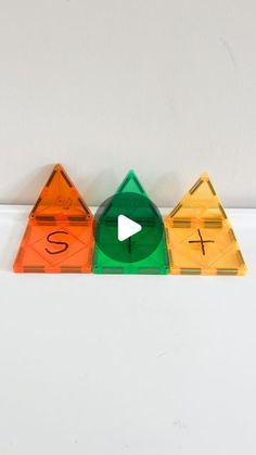 three plastic pyramids with numbers on them and one has an arrow in the middle