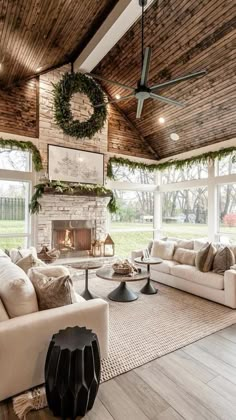 a living room filled with furniture and a fire place in the middle of an open floor plan