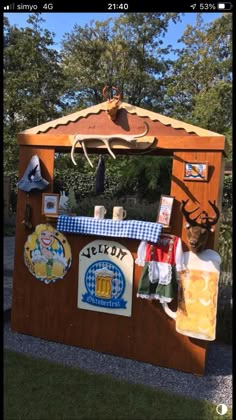 an outdoor bar is decorated with deer heads and beer mugs on the outside wall