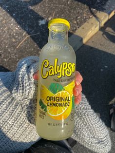 someone holding up a bottle of calypps lemonade