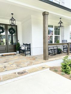 the front porch is clean and ready to be used for entertaining on an outdoor patio