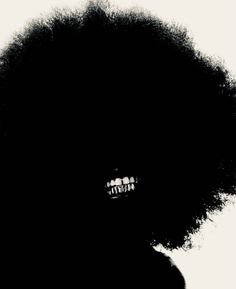 the silhouette of a woman's head with an afro in front of her face