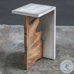 a small wooden table sitting on top of a cement floor