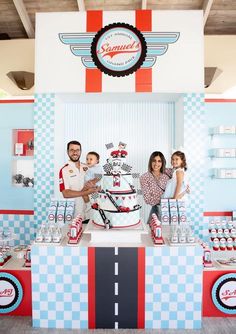 a man and two women standing in front of a cake on display at a store