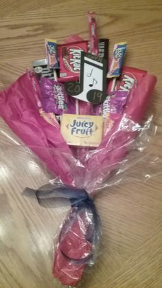 the candy bouquet is wrapped in pink plastic