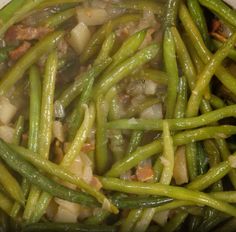 cooked green beans and onions in a pot