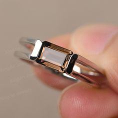 This is a gorgeous handmade creation. Its beauty is its simplicity & Elegance. The 7X5mm Emerald cut real smoky quartz is crafted in solid sterling silver and with rhodium plated. It is available to customized, if you have any mind, just let me know, we will discuss with it. All item is sent in a beautiful gift box You can realize more lovely stuff clicking the link https://www.etsy.com/shop/knightjewelry?refshopsection_shophome_leftnav Please leave the correct address and you PHONE NUMBER for d Minimalist Brown Sterling Silver Jewelry, Elegant Smoky Quartz Jewelry For Anniversary, Formal Silver Smoky Quartz Jewelry, Classic Smoky Quartz Jewelry As A Gift, Classic Smoky Quartz Jewelry As Gift, Modern Sterling Silver Crystal Ring With Polished Finish, Elegant Smoky Quartz Gemstone Rings, Elegant Smoky Quartz Rings For Anniversary, Minimalist Silver Topaz Ring For Formal Occasions