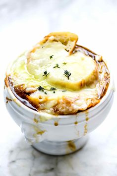 a white bowl filled with food on top of a table