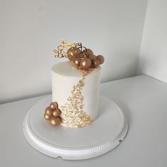 a white cake with gold decorations on top