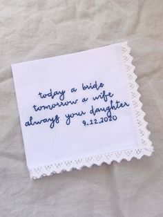 a white handkerchief with blue writing on it that says today a bride tomorrow a wife always your daughter