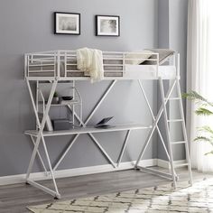 a white loft bed sitting on top of a wooden desk