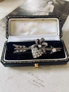 an absolutely outstanding bar brooch dating from the later Victorian period around 1880 compromising of an arrow through and intricate heart locket set in 935 and set with old cut paste crystal rhinestones which catch the light at every angle.  A wonderful piece of sweetheart jewellery with lots of history measuring 5.3 cm by 2.5 cm.  Please note all boxes and decorations are for display only and not included in the listing.  All items are of at least antique or vintage era unless otherwise stat Vintage Brooches With Single Cut Diamonds For Anniversary, Antique Diamond Brooch As Gift, Antique Diamond Brooches As Gifts, Antique Diamond Brooch For Gift, Vintage Brooches With Single Cut Diamonds As Gift, Vintage Brooches With Single Cut Diamonds For Gifts, Vintage Single Cut Diamonds Brooches For Gift, Vintage Brooch For Valentine's Day Formal, Antique Heart Brooch For Wedding