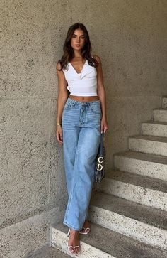 Make weekend styling simple with the One Call Away Jeans in Vintage Mid Blue. These mid rise, relaxed fit jeans feature wide leg style, silver button closure, belt loops and 5 pocket design. We love this paired with a cute crop top and sneakers for the perfect off-duty look!  - 100% Cotton - Ash is 166cm & is wearing an XS    AS SEEN ON…@JODIEBRINE & @DEKOTA_THOMPSON Model Casual Outfit, Mid Rise Jeans Outfit, High Rise Jeans Outfit, Jeans And Crop Top Outfit, Summer Outfit Guide, Jeans Pants Outfit, Straight Jeans Outfit, Straight Leg Jeans Outfits, Look Zara