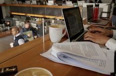 people sitting at a table with papers and laptops