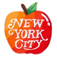 an apple with the words new york city written in white ink on a white background