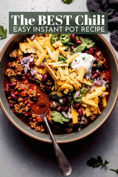 a bowl filled with chili and cheese on top of a table