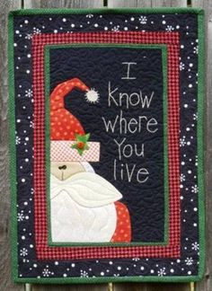 i know where you live santa clause quilted on wood fence with snowflakes