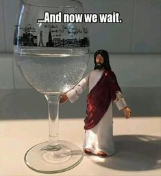 a jesus figurine standing next to a glass of water with the caption jesus do your job