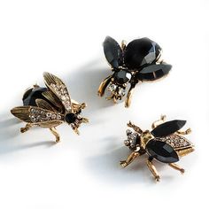 "You get all 3 pins in this fabulous set! Graceful, hardworking, confident and just a tad eerie... channel your inner Queen Bee every time you wear these mysterious bee pins! Each of these elegant bee pins are 3-D, set with premium crystal. Resting daintily on their legs, faceted jet black and clear crystal fills their bodies and wings finished in 14k gold. Size: Largest Bee is 1.25\" L x 1.25\" W Smaller Bees are 1\" L x 1\" W Made in our Los Angeles studio. Objects of desire: the Elvira Jewelr Black Bee, Small Bees, Bee Pin, Locket Bracelet, Bee Jewelry, Bee Brooch, Insect Jewelry, Sweet Romance, Queen Bee