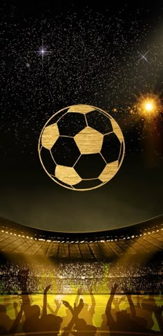 a soccer ball flying through the air over a stadium full of people watching it with their hands in the air