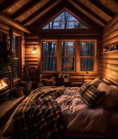 a log cabin bedroom with a bed and fireplace in the corner, lit up by lights