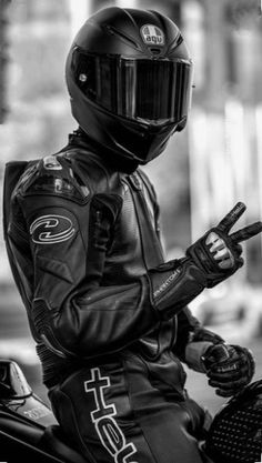 black and white photograph of a person on a motorcycle wearing a leather outfit with the words fastlane written on it