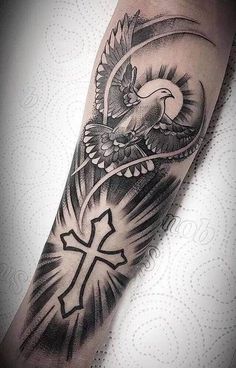 an eagle and cross tattoo on the arm