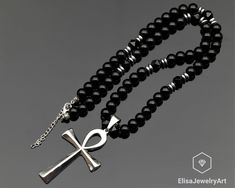 Ankh Cross Necklace Natural Black Onyx Beaded Necklace Stress Crystal Gemstone Strong Clasp Necklace Anxiety Necklace -ALL THE PRODUCTS AT ELISAJEWELRYART ARE HANDMADE AND MADE WITH NATURAL BEADS. -WHAT DOES THE ONYX STAND FOR    A powerful protection stone, Black Onyx absorbs and transforms negative energy, and helps to prevent the drain of personal energy. Black Onyx aids the development of emotional and physical strength and stamina, especially when support is needed during times of stress, c Ankh Cross, Physical Strength, Personal Energy, Cardboard Jewelry Boxes, Clasp Necklace, Protection Stones, Onyx Bead, Adjustable Necklace, Natural Beads