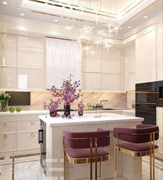 a kitchen with white cabinets and marble countertops has purple chairs around the island, while gold trimmings hang from the ceiling