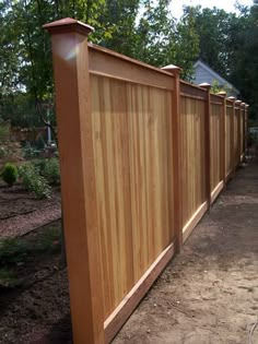 a wooden fence in the middle of a yard