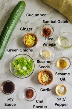 the ingredients for cucumber salad laid out on a marble counter top with their names