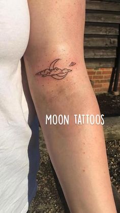 a woman with a tattoo on her arm and the words moon tattoos written below it