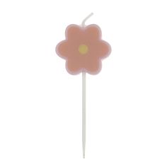 a pink flower shaped cake topper on a white stick with a yellow dot in the center