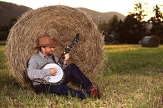 a man sitting in the grass with a bagpipe