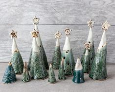 a group of ceramic christmas trees sitting next to each other