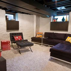 a living room filled with lots of furniture next to a wall mounted flat screen tv