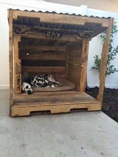 a dog bed made out of pallet wood with a dalmatian sleeping in it