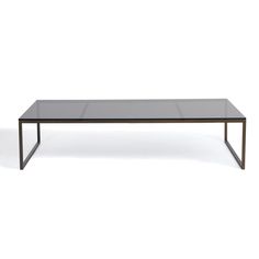 a glass and metal coffee table on a white background with no one around it,