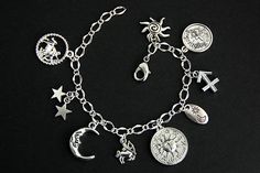 A collection of silver plated Sagittarius zodiac themed and celestial themed charms have been dispersed around a shimmering silver plated bracelet chain in this handmade charm bracelet. This Sagittarius sun sign bracelet is then completed with a lobster clasp and a 1/2 inch of chain at the end for adjustable sizing. Charms in this bracelet include four Sagittarius charms, a sun and moon tab charm, a pair of stars charm, moon charm, sun charm, and a double sided full zodiac charm. ● Sizing ● To d Adjustable Silver Celestial Charm Bracelet, Celestial Silver Metal Bracelets, Celestial Style Silver Metal Bracelets, Silver Zodiac Sign Symbolic Bracelets, Silver Zodiac Sign Bracelet, Silver Zodiac Sign Symbolic Bracelet, Symbolic Zodiac Sign Bracelet Jewelry, Sagittarius Bracelet, Sagittarius Sun