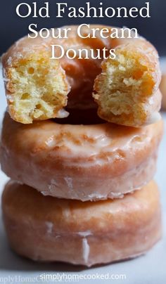 three glazed doughnuts stacked on top of each other with the words old fashioned sour cream donuts