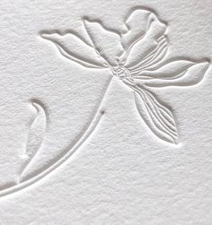 a white paper with a flower on it