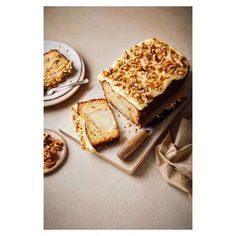 two slices of cake sitting on top of plates next to another piece of cake with walnuts