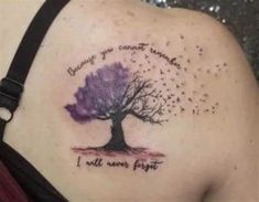 a woman's back shoulder with a tree on it and words written in purple ink