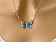 This silver butterfly necklace features a dainty teal butterfly, a beautifully detailed antiqued silver plated pewter butterfly pendant with sparkly blue and green enamel, hanging from a sterling silver or silver plated chain that secures with a lobster clasp. Easily dresses up or down. Length: choose 16 to 30 inches (shown at 18 inches) Pendant: 1 x 1 3/8 inches Arrives with a Marty White card in a lovely decorative bag, all wrapped in tissue paper and bubble wrap packaging. **Mark my shop as a Elegant Silver Metal Butterfly Necklace, Silver Metal Butterfly Necklace, Nickel-free Sterling Silver Butterfly Necklace, Nickel-free Sterling Silver Butterfly Pendant Necklace, Nickel Free Sterling Silver Butterfly Necklace, Silver Metal Necklace With Butterfly Charm, Silver Necklace With Butterfly Charm, Elegant Turquoise Butterfly Jewelry, Sterling Silver Jewelry With Butterfly Clasp