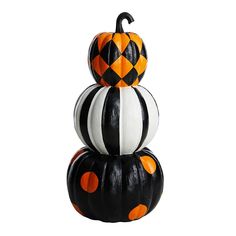 three pumpkins stacked on top of each other with black and white stripes around them