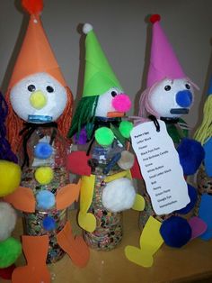 there are many colorful hats and decorations on the table with paper tags attached to them